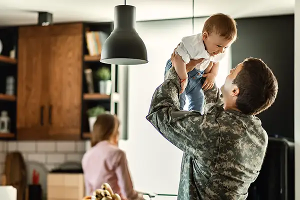 Man in US military uniform in kitchen with family