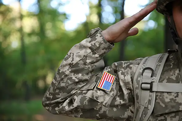 Close up of soldier in US military uniform taking salute