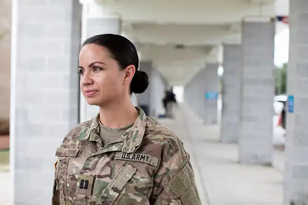 Soldier wearing US Army military uniform and standing outside