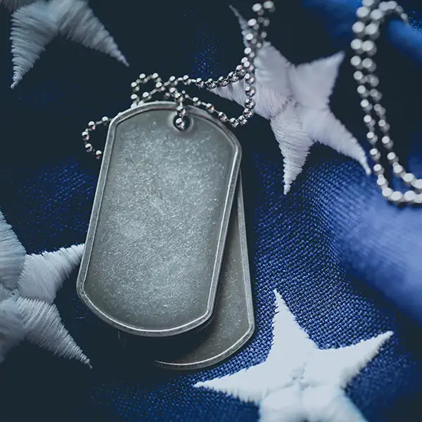 USA military dog tags close up on US American flag