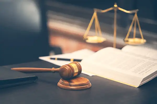 Judge gavel with law book on wooden table